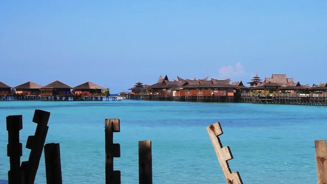 Tropical Paradise at Mabul island with palms and blue sky