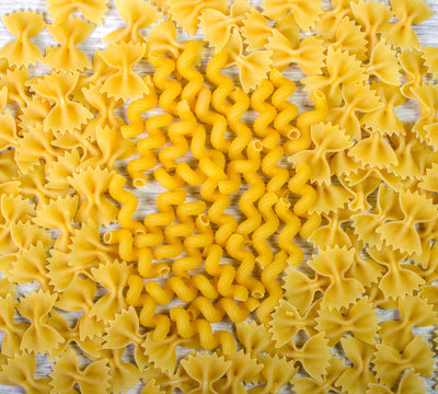 two kinds of pasta on a wooden table, background

