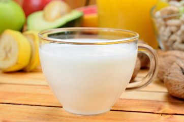 cup of milk with fruit on table