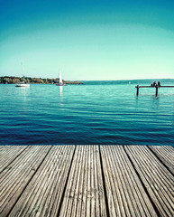 Fototapeta na wymiar Couple dreaming on water jetty by lake