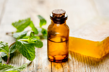 organic cosmetics with herbal extracts of mint on wooden background