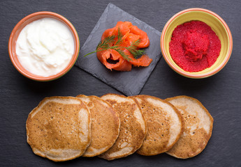 Russian buckwheat pancakes blini with cream and caviar