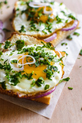 Open sandwiches with egg and cheese on a wooden background