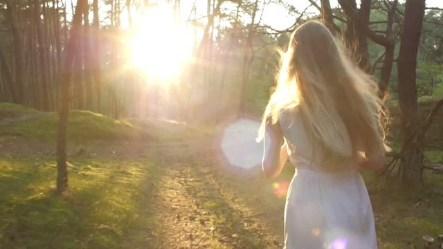 Blonde girl in a white dress running