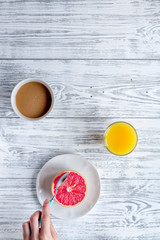 Breakfast concept with flowers on wooden background top view