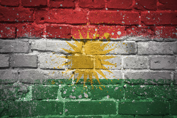 painted national flag of kurdistan on a brick wall