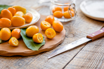 kumquat on plate at wooden table