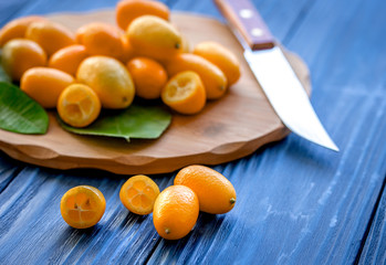 kumquat on plate at wooden table