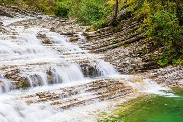 Waterfall and rocks. Beautiful nature. Summer