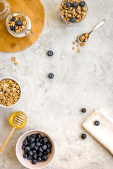 Oat flakes and berries granola glass on table background top view