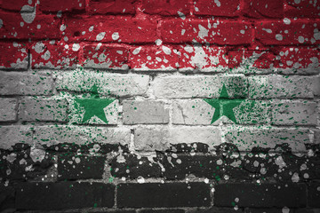 painted national flag of syria on a brick wall