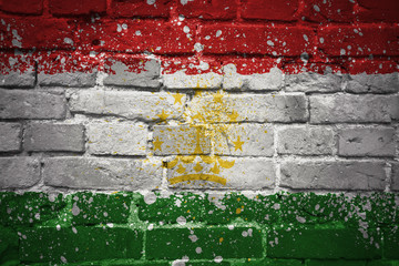 painted national flag of tajikistan on a brick wall