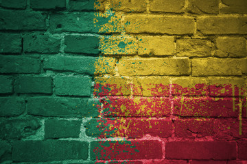 Fototapeta premium painted national flag of benin on a brick wall