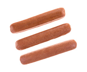 Top view of three uncured beef hot dogs isolated on a white background.