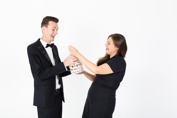 Couple in black clothes with decorative cell smiling 