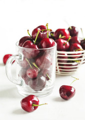 Fresh sweet cherry in glass cup