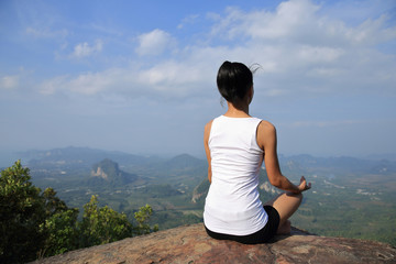 Fototapeta na wymiar young woman practice yoga at mountain peak