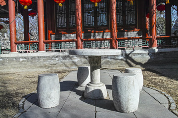 Fototapeta na wymiar A stone table and benches in Chinese garden