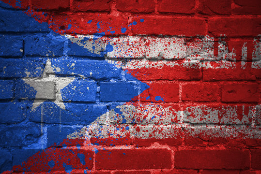 painted national flag of puerto rico on a brick wall