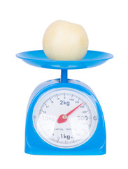 Chinese pear on kitchen scale isolated on white background