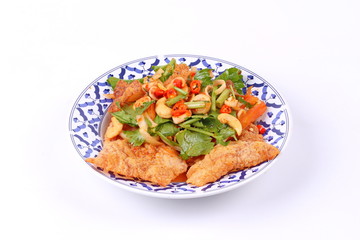 Spicy and sour mixed herb salad with crispy pork served .