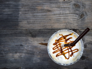 Ice coffee on wooden table, top view, copy space