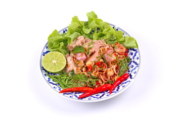 Spicy and sour mixed herb salad with tuna served .