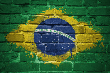 painted national flag of brazil on a brick wall © luzitanija