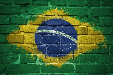Poster de jardin Brésil painted national flag of brazil on a brick wall