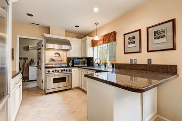 Nicely remodeled kitchen with glossy granite counter tops
