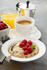 Steel cut oatmeal porridge with raspberry and coconut