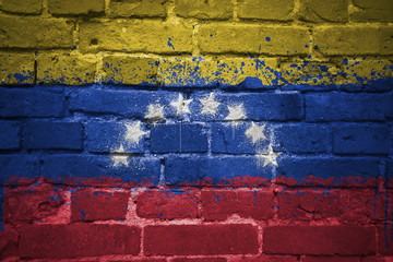 painted national flag of venezuela on a brick wall © luzitanija