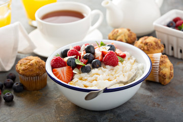 Rice pudding with fresh berries and coconut for breakfast