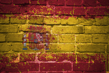 painted national flag of spain on a brick wall