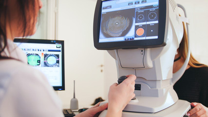 High technology health care - ophthalmologist in eyes clinic working with patient by modern...