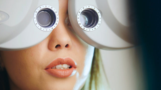 Ophthalmology Clinic - Woman Checks Vision By Modern Equipment - Eyes Exam, Close Up