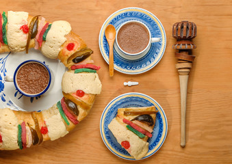 Epiphany cake, Kings cake, Rosca de reyes slice with  a cup of hot Chocolate and molinillo, top view
