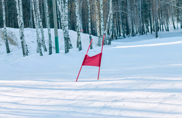 Slalom flag standing in the snow on the ski slopes