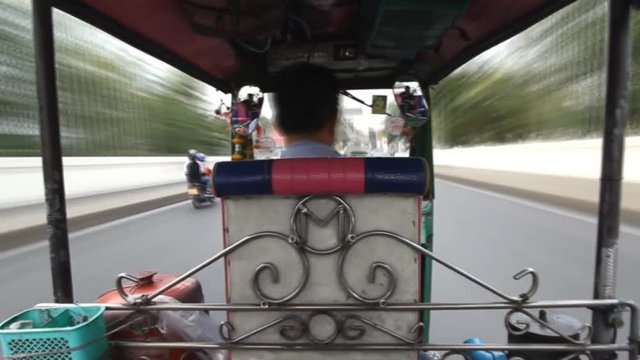 Time Lapse, Tuk Tuk driving on street in Bangkok, Thailand. A popular three-wheeled taxi transport in Bangkok.