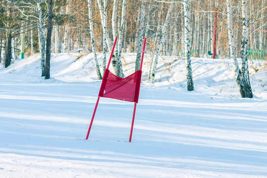 Slalom flag standing in the snow on the ski slopes