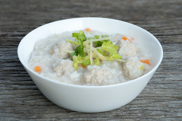 Traditional porridge rice with pork  in white bowl.
