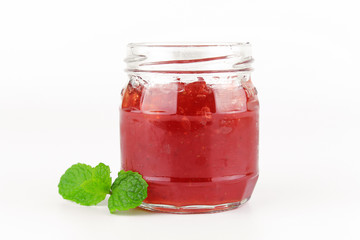 fresh strawberry jam in glass bottle with mint leaf