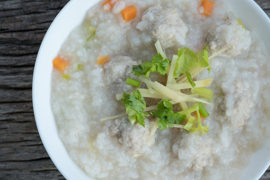 Traditional porridge rice with pork  in white bowl.