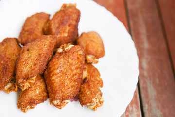 Chicken flied on white dish.