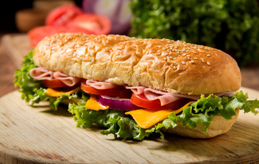 Sandwich with ham on a table, tomato and chees,  bread