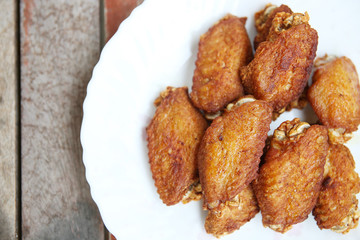 Chicken flied in white dish.