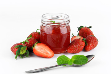 fresh strawberry jam in glass bottle with mint leaf