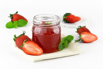 fresh strawberry jam in glass bottle with mint leaf