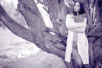 sad young thoughtful girl in the park