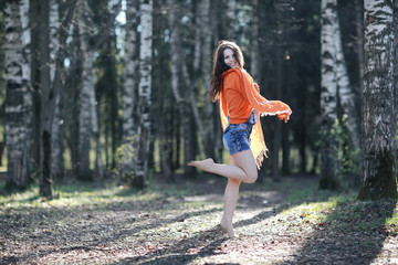 cheerful and happy young girl in the spring forest
